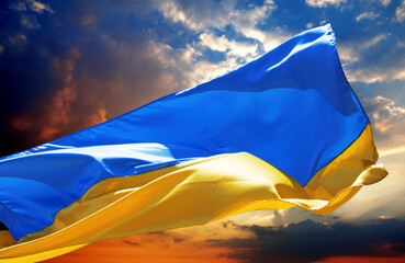 Flag of Ukraine waving on sunset peaceful sky with danger clouds - 489598976