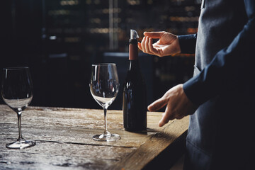 Man sommelier talks about aroma and taste of red wine at tasting in restaurant