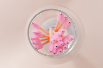 Set of pink brushes in glass on light background. Flat lay copy space beauty fashion top view