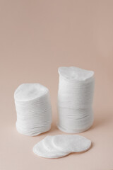 Fototapeta na wymiar Cotton pads on light pink background, minimalism beauty fashion top view