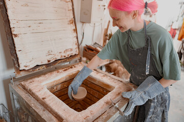 Female master ceramist working at her studio