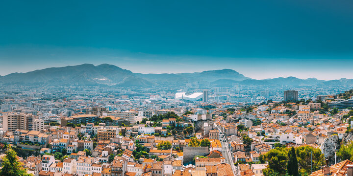 Urban panorama, aerial view, cityscape of Marseille, France. Sunny summer day with bright blue sky. Cityscape of Marseille, France. Urban background with sport Velodrome stadium. Stade Velodrome.