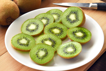Kiwi fruit on a white plate.