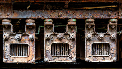 Grunge steam-punk mechanical background close-up of rusty train locomotive parts 