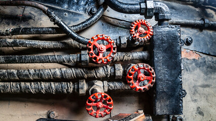 Grunge steam-punk mechanical background close-up of train locomotive parts, control valves, dials and knobs
