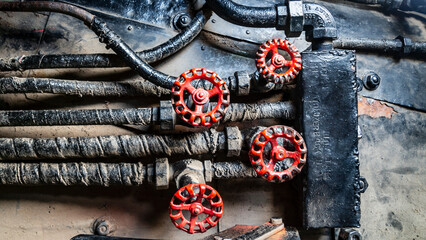 Grunge steam-punk mechanical background close-up of train locomotive parts, control valves, dials...