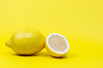 Ripe lemons on yellow background