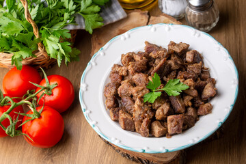 Muslims Traditional Sacrifice holiday food lamb, Turkish roasted meat in copper pot on table top. Turkish Kavurma. (Turkish name; Kurban kavurma)