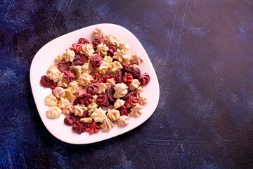 homemade multi-colored pastille from apples and berries on a white plate.