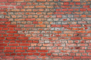 red brick old building wall in the city center as a texture background