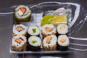 Prepared Japanese sushi, the background is dark.