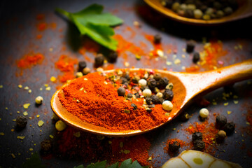 spice pepper in a spoon on a dark background