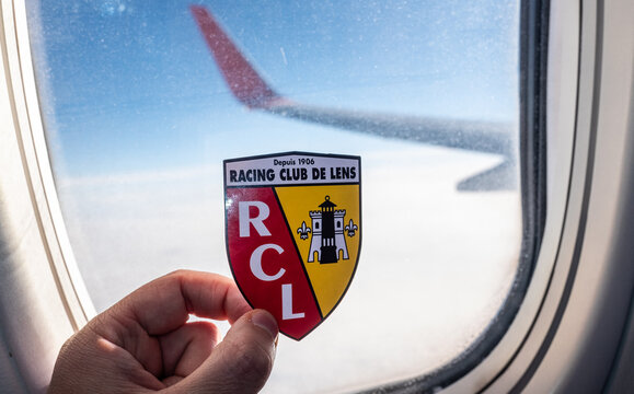 December 6, 2021. Lens, France. The emblem of the RC Lens football club on the background of the airplane window.