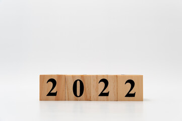 2022 written on wooden blocks in horizontal direction isolated on white background with copy space