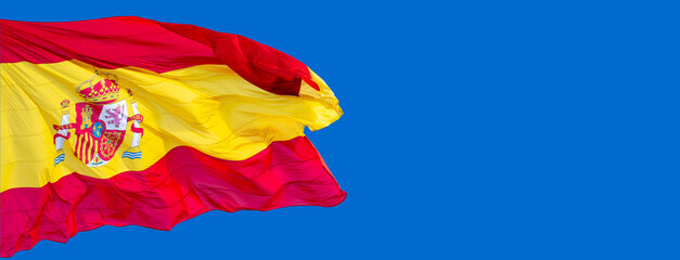 spain flag in the wind with blue sky background. - obrazy, fototapety, plakaty