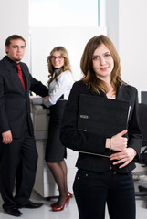 Smiling young businesswoman in office