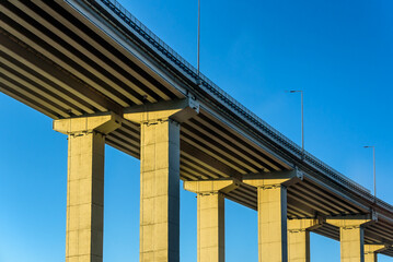 Highway Road bridge on columns with blue sky in the background. Straight road line with empty copy space.