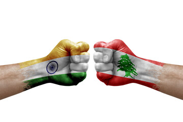Two hands punch to each others on white background. Country flags painted fists, conflict crisis concept between india and lebanon