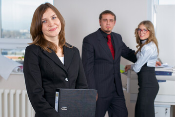 Smiling young businesswoman in office