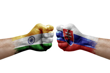 Two hands punch to each others on white background. Country flags painted fists, conflict crisis concept between india and slovakia