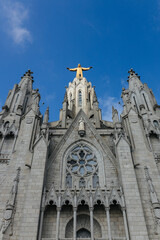 Christ statue on top of the Temple of the Sacred Heart of Jesus church on mount Tibidabo in Barcelona, Spain