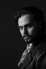 Black and white photo of bearded stylish handsome confident man. Vertical.