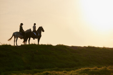 A horse is the projection of peoples dreams. Shot of two unrecognizable women riding their horses...