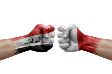 Two hands punch to each others on white background. Country flags painted fists, conflict crisis concept between iraq and malta