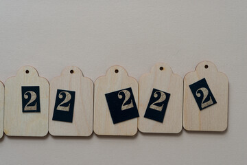 a set of wooden tags with the number two on paper