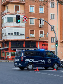 Madrid Police Patrol Car, Cutting Through A Street Under A Green Traffic Light. Madrid, Spain.