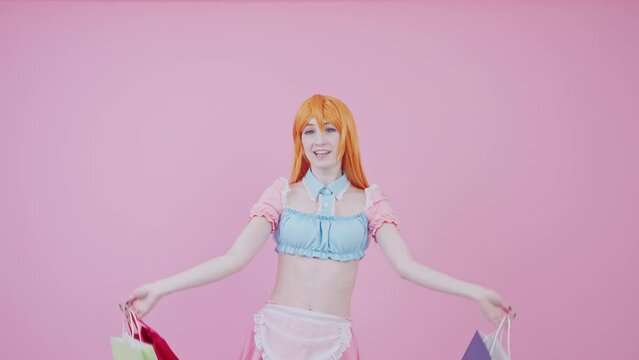 pretty millennial cosplayer model carries many packs shopper enjoys tourism abroad isolated pink background. High quality 4k footage