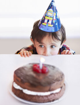 I Just Want A Little Taste.... A Cute Little Boy Looking At His Birthday Cake In Anticipation.