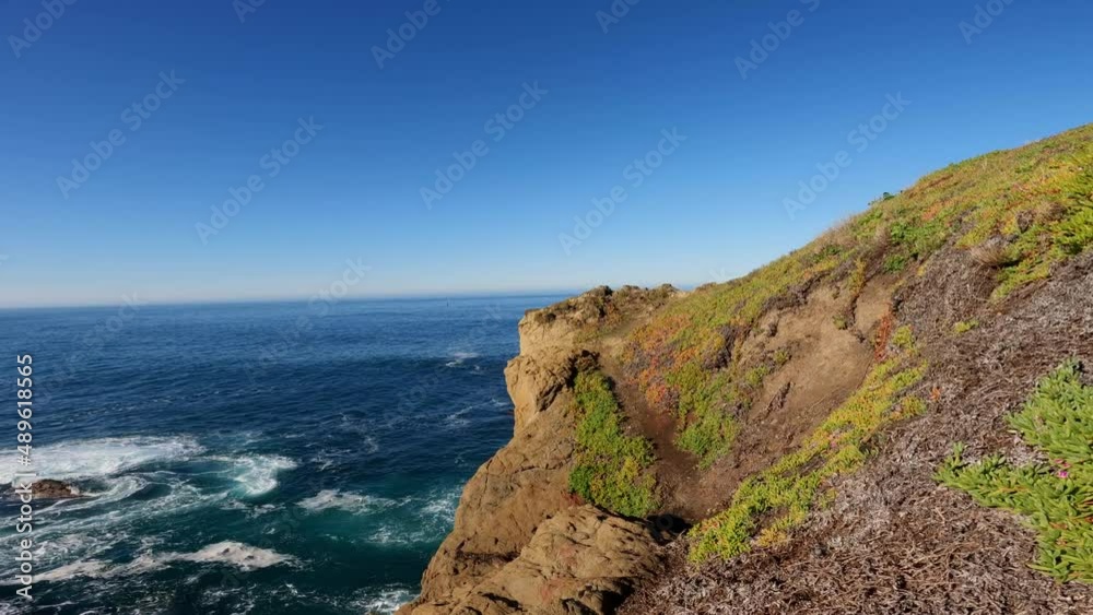 Wall mural Hiking on a dangerous trail on cliff near ocean 