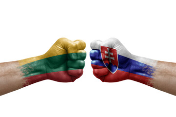 Two hands punch to each others on white background. Country flags painted fists, conflict crisis concept between lithuania and slovakia