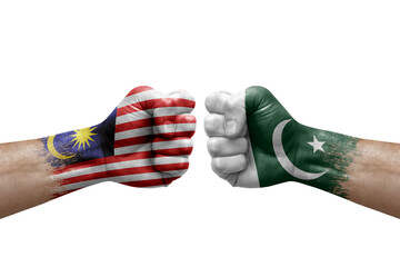 Two hands punch to each others on white background. Country flags painted fists, conflict crisis concept between malaysia and pakistan