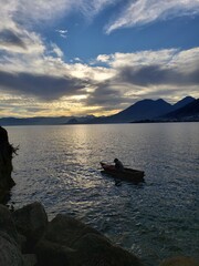 Naklejka na ściany i meble fishing in a lake surrounded by volcanoes