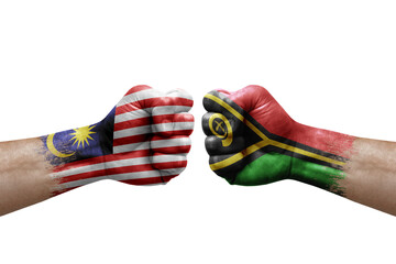 Two hands punch to each others on white background. Country flags painted fists, conflict crisis concept between malaysia and vanuatu