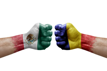 Two hands punch to each others on white background. Country flags painted fists, conflict crisis concept between mexico and romania