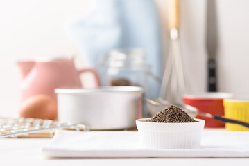 Organic perilla seeds in a ceramic bowl on white background. Natural products, healthy baking ingredients