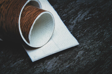 Linoleum. Roll of linoleum on a black background. Floor coverings.