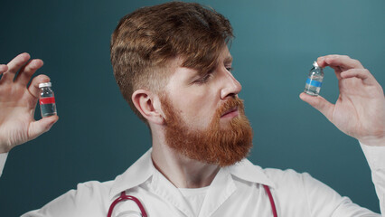 An attractive young doctor tries comparing two ampules with vaccine