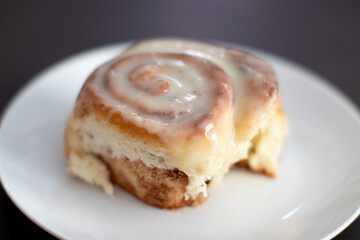 Closeup of a single cinnamon roll with frosting