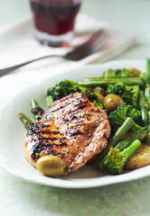 Grilled Turkey Breast with oven baked potatoes and broccoli. Close up.	