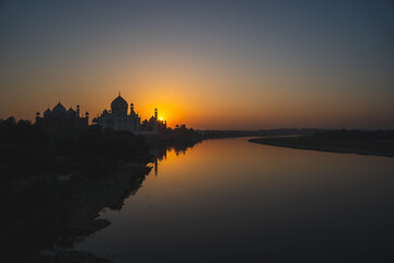 A wide angled view of Taj Mahal in Agra captured with Yamuna River beside. Taj Mahal during sunset...
