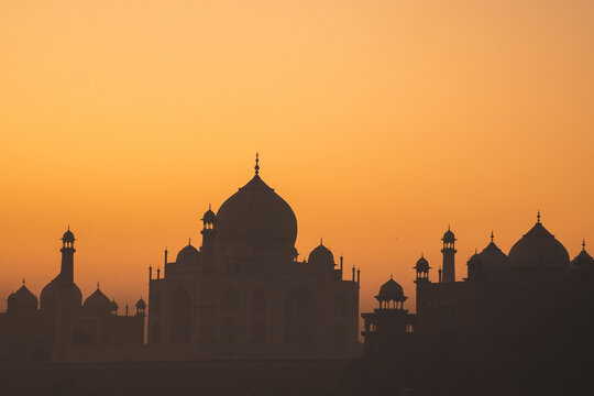 Silhouette of Taj Mahal captured during sunrise. Golden sky in Agra.