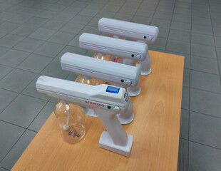 Malaysia,Perak,22 Febuary 2022: Wireless rechargeable nano blue ray atomizer spray gun on wooden...