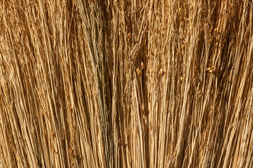 close-up old handmade straw brooms background