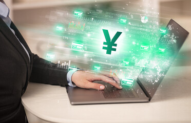 Young man watching stock market on laptop