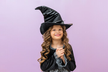 A girl in a carnival witch costume. A witch's costume for halloween. A little girl in a fairy costume.