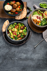 Brussel sprout salad with bulgur on dark background.